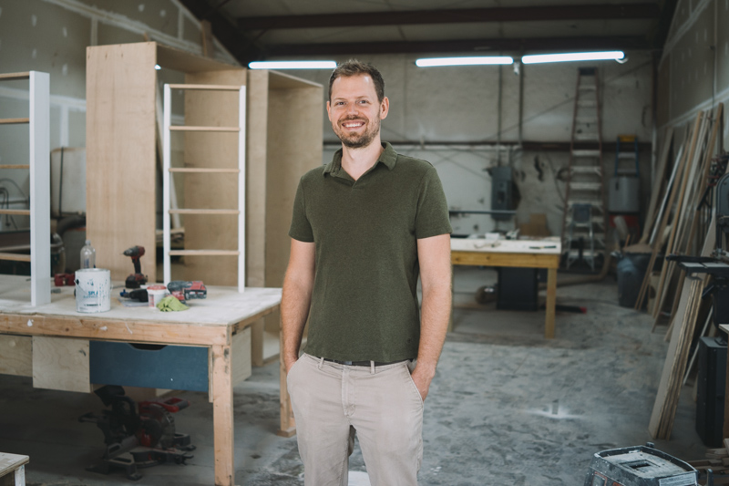 Cody standing in front of the workshop.