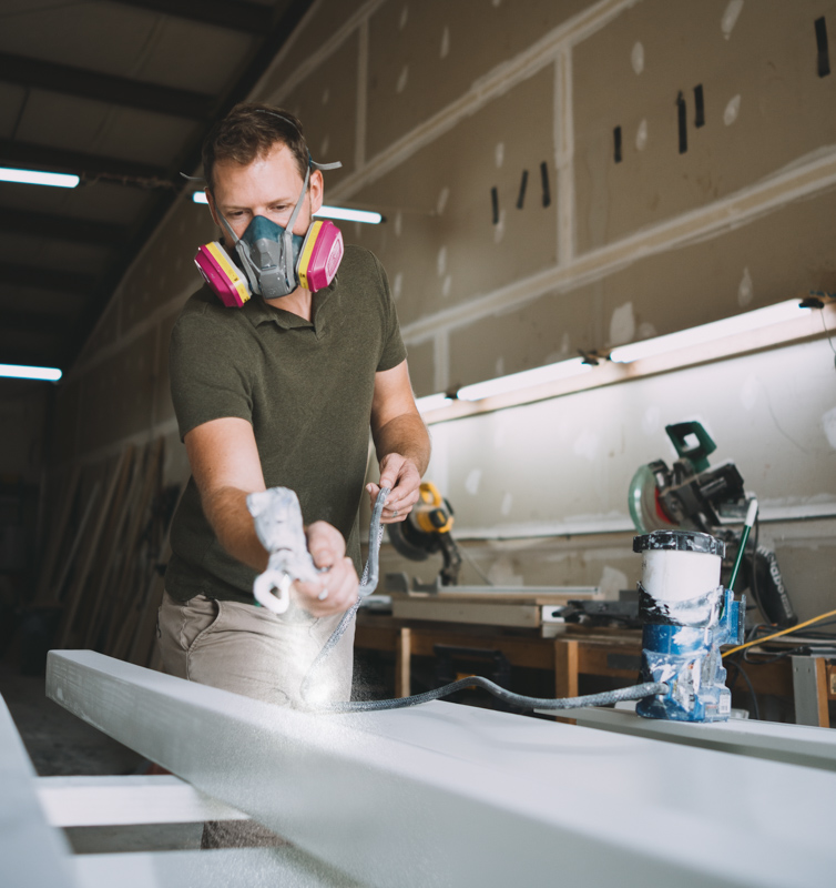 Cody painting posts.