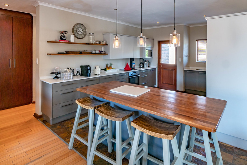 A kitchen with an island and stools.